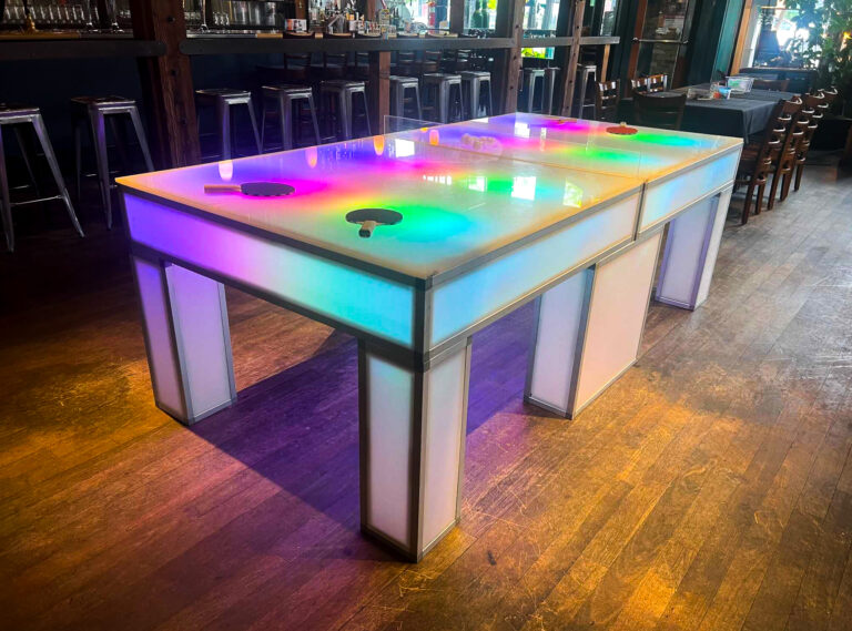 LED glow ping pong table illuminated with colorful lighting at Squatters Pub in Salt Lake City.