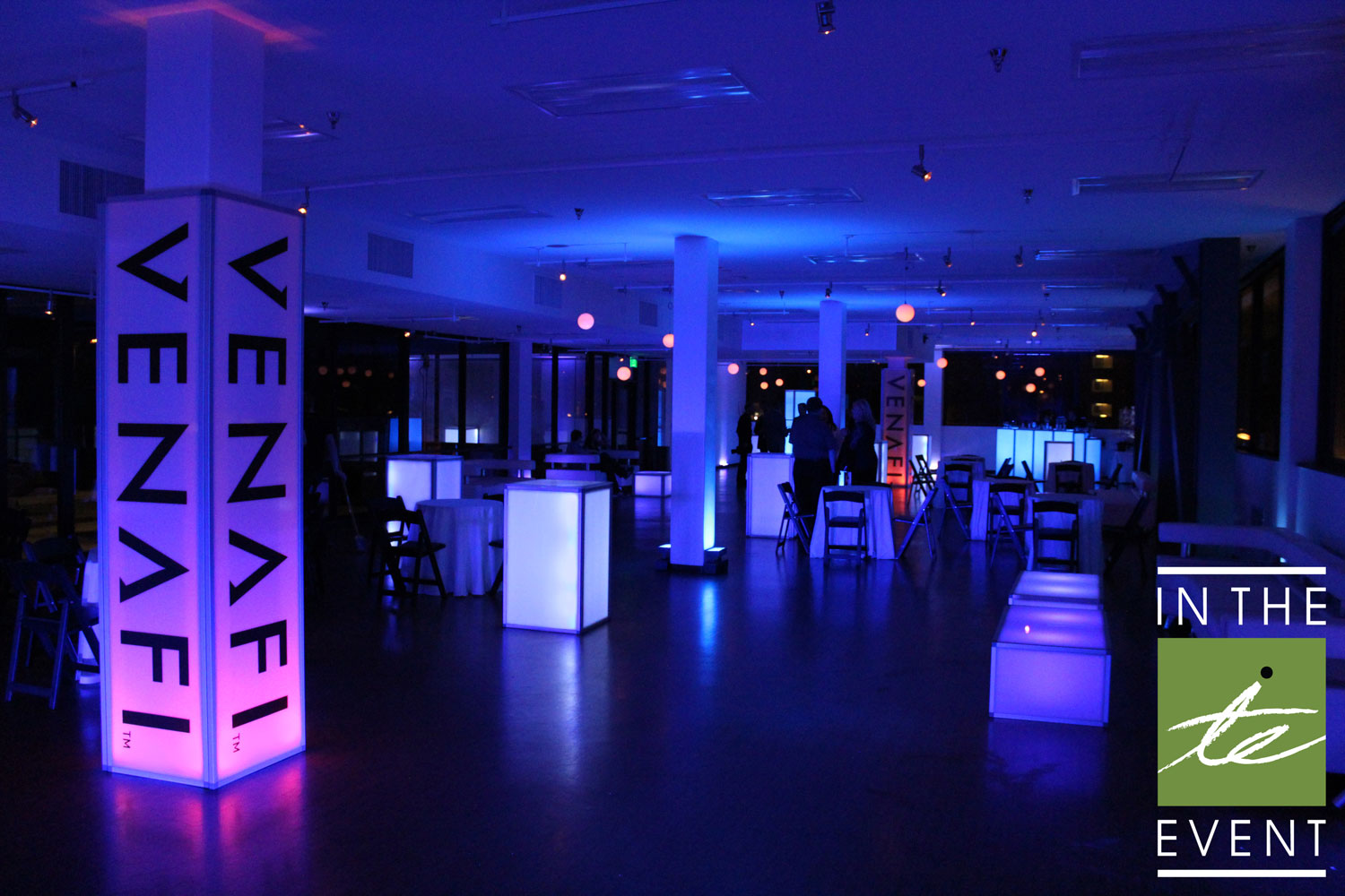 Venafi branded corporate event featuring glowing LED cocktail tables and modern lounge setup with blue and purple lighting.