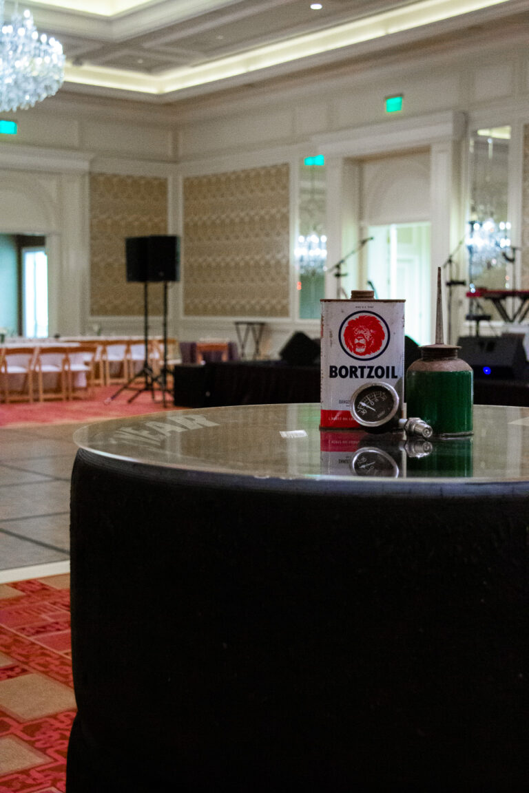 A vintage oil-themed centerpiece on a table made from Goodyear tires at the Zoetis Access DMC event.