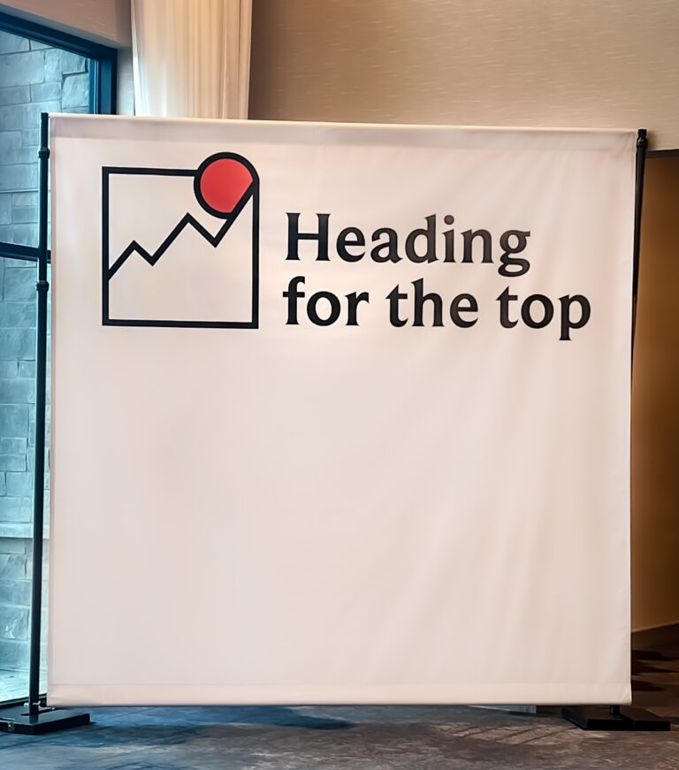 Custom event backdrop with bold graphic design and motivational theme