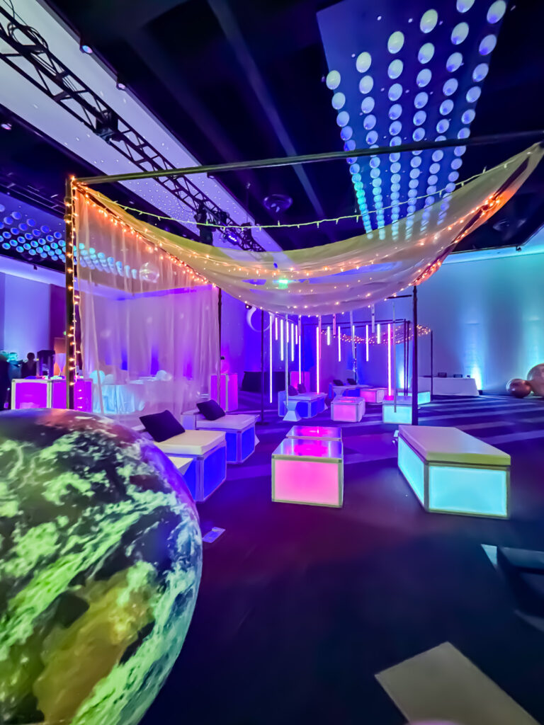 Modern white LED sofas and LED side tables set up for indoor event seating.