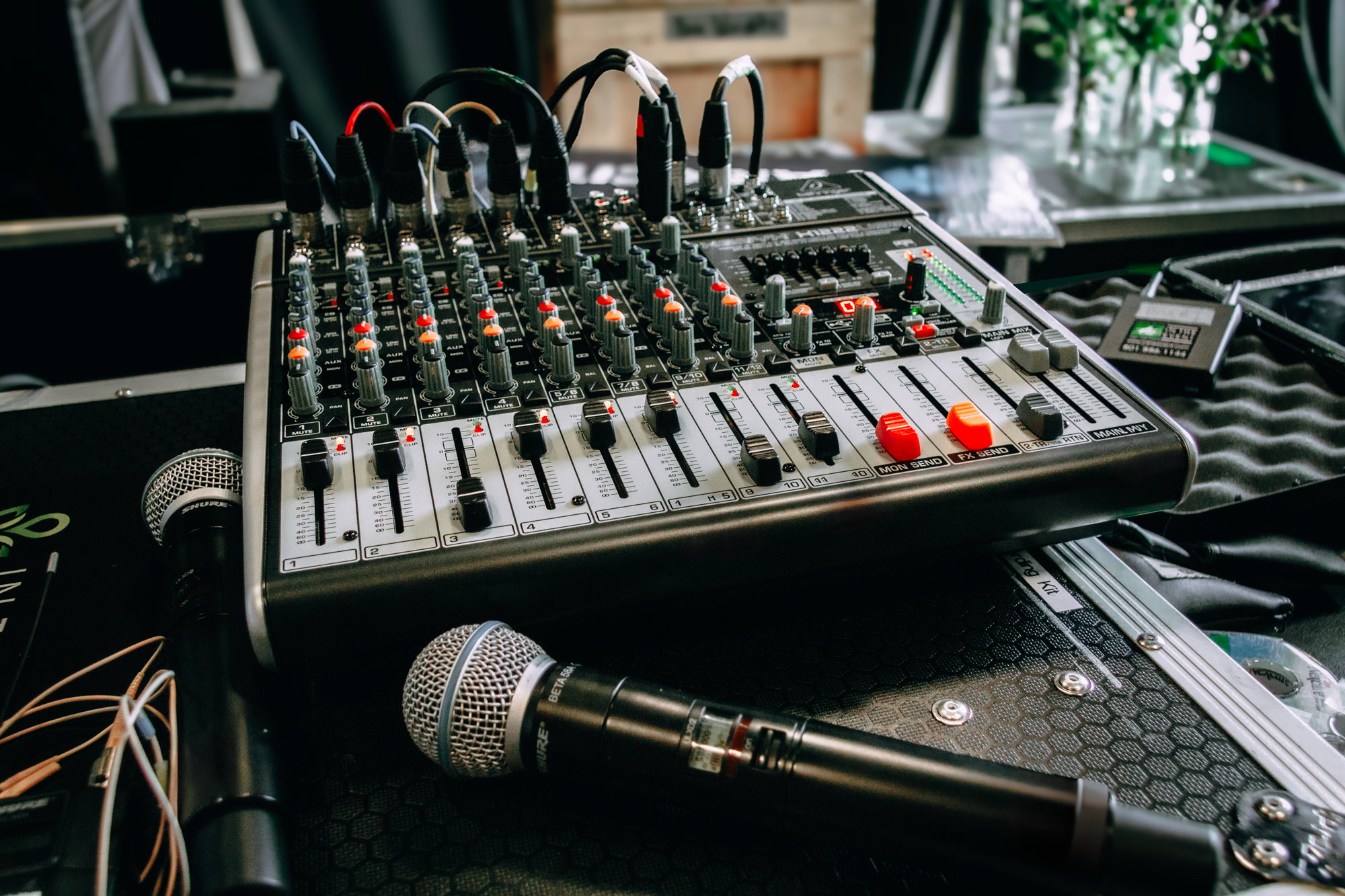 Audio mixer board with microphone for live event sound management.