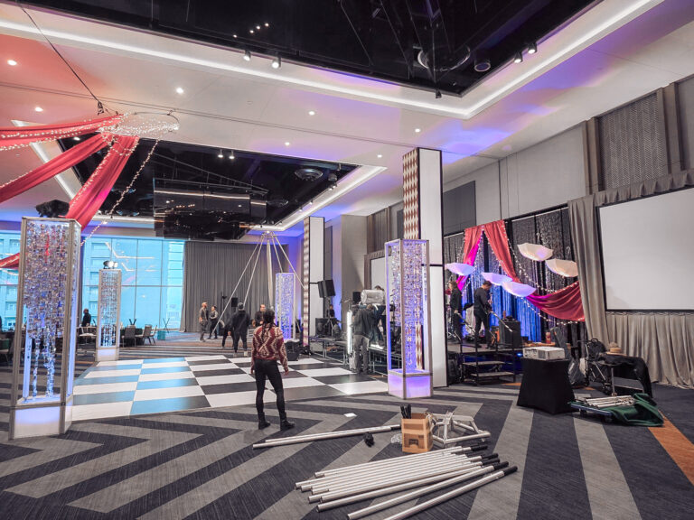 Event crew assembling stage and dance floor decor for the SILAC Insurance Gala