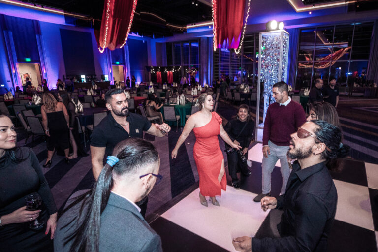 Group of guests dancing and celebrating on the checkered dance floor at the SILAC Insurance Gala