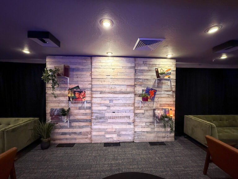 custom wooden wall display with album art and greenery decor at Vizio Lounge during Sundance event