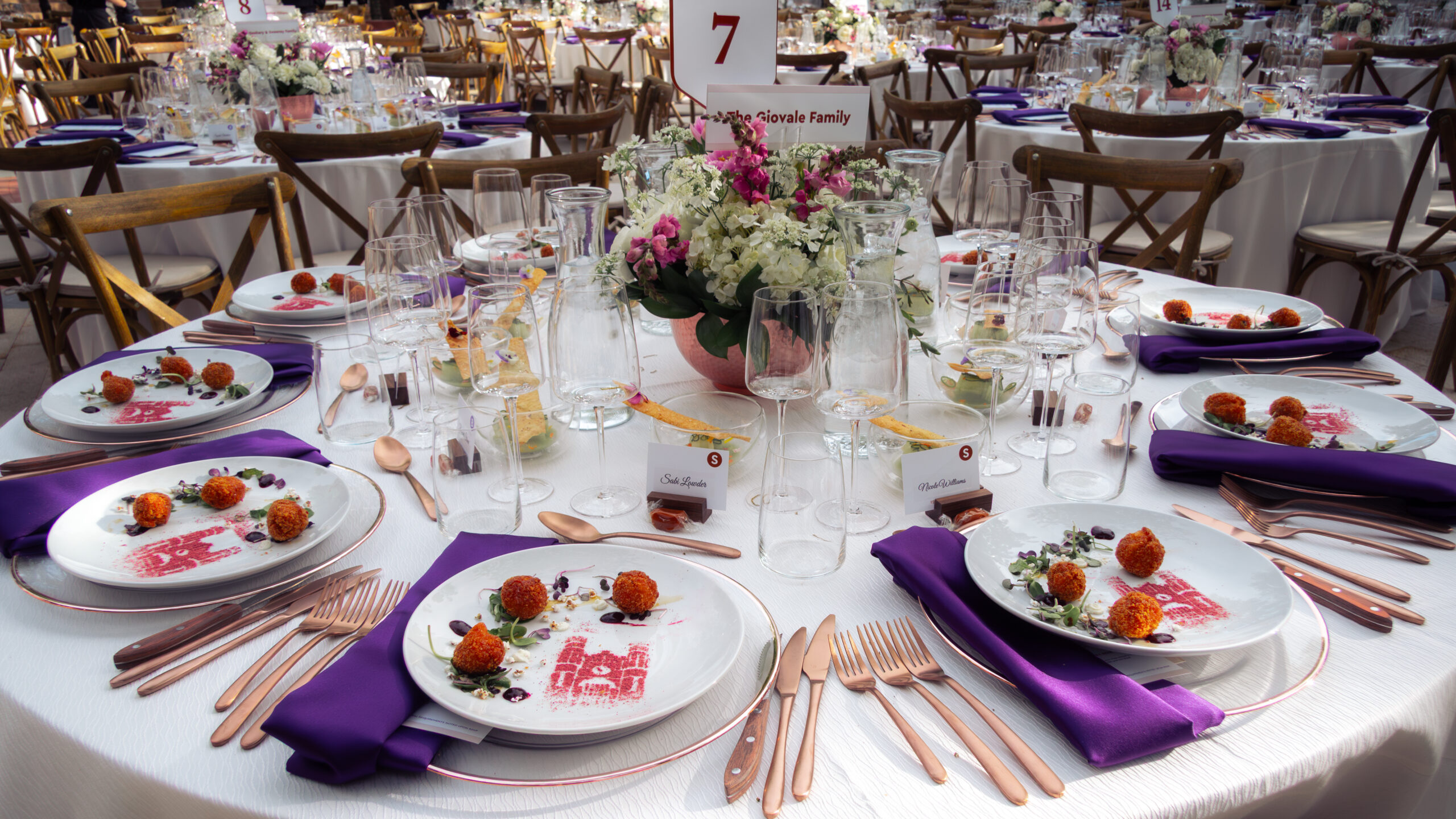 Westminster University Sesquicentennial Gala, table setting with purple napkins and copper centerpiece