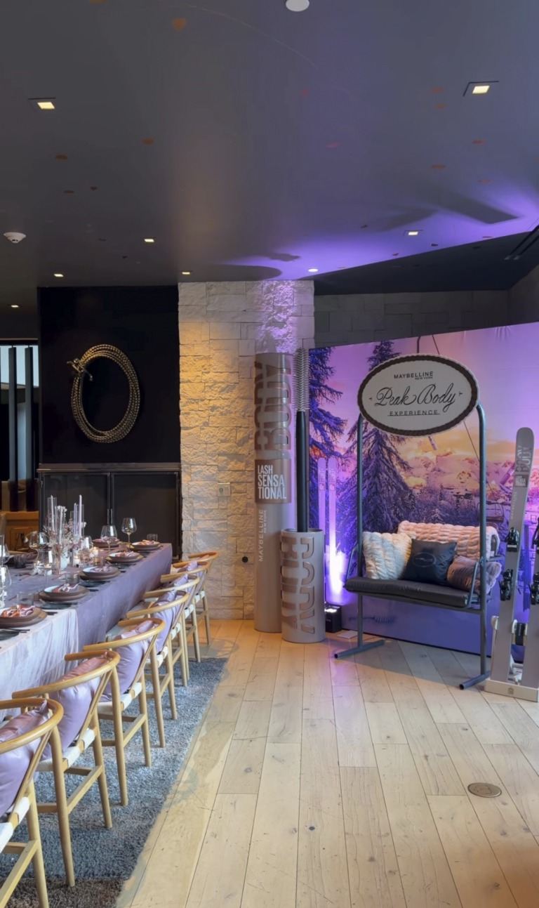 Event furniture, ski lift chair photo op, custom SEG backdrop, branded graphics, and florals for Maybelline New York Peak Body Experience at Blue Sky Lodge in Utah by In The Event