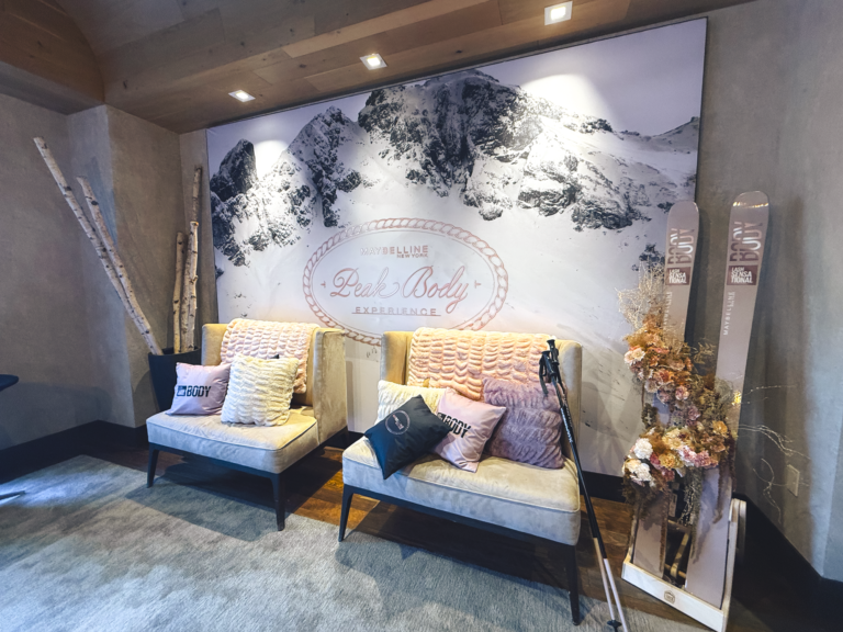 Photo op with custom SEG backdrop, Aluvision frames, custom pillows, florals, and birch wood sticks for Maybelline New York Peak Body Experience at Blue Sky Lodge in Utah by In The Event
