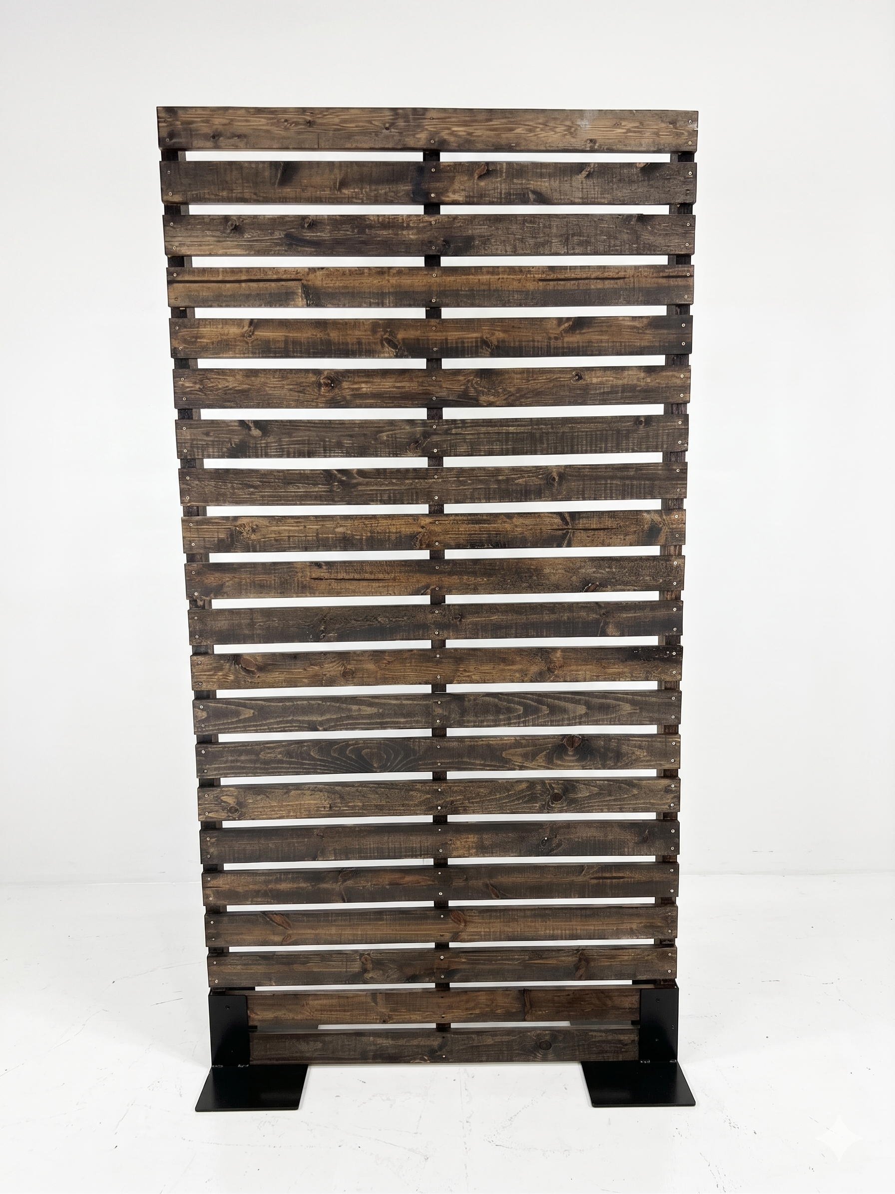 Front view of freestanding dark stained wood pallet wall panel on black metal base for rustic themed event decor rentals and corporate event production in Salt Lake City Utah