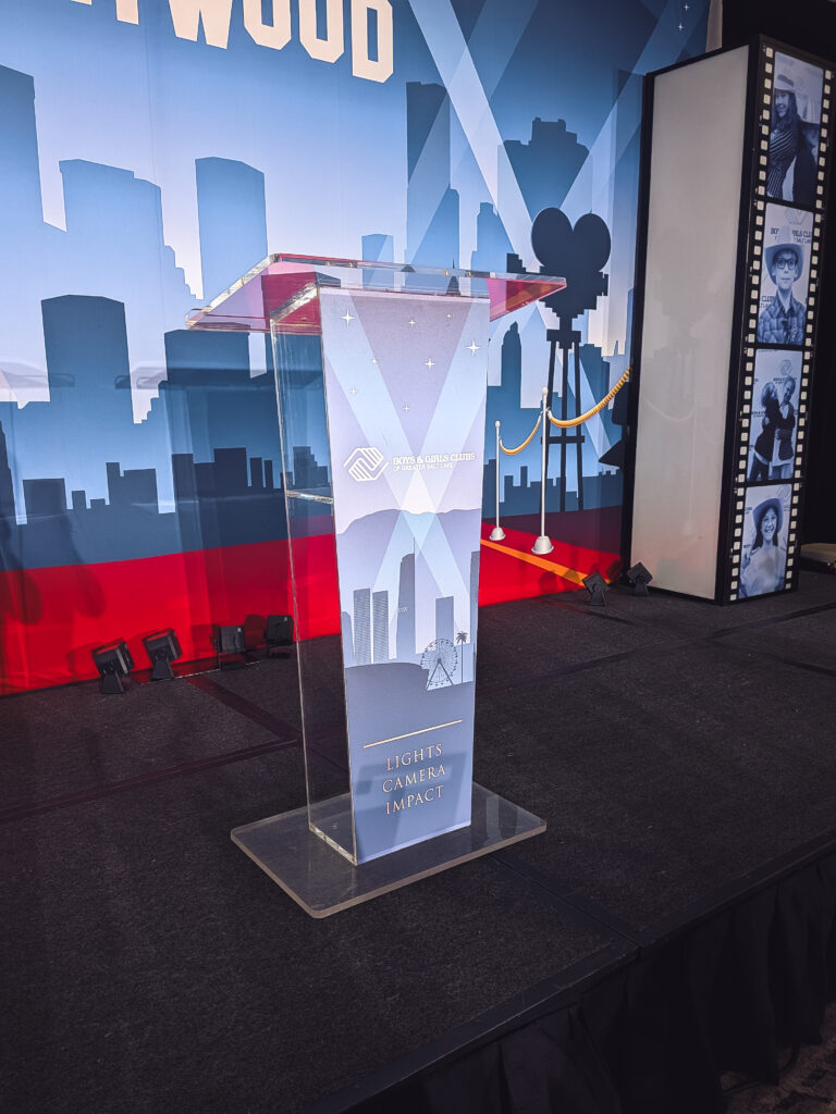Custom branded acrylic podium positioned on a Hollywood-themed event stage at the Boys & Girls Great Futures Event at Marriott City Creek Downtown in Salt Lake City.
