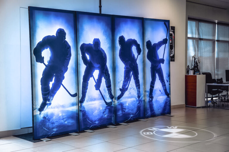 Large-format custom hockey graphics printed on wall panels for a BMW event at BMW of Murray.