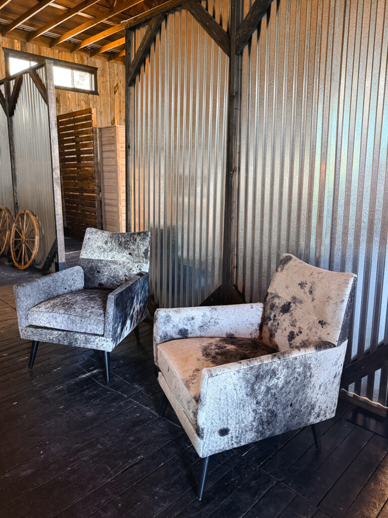 Cowhide accent chairs displayed in a rustic Western venue at Lodges at Blue Sky.