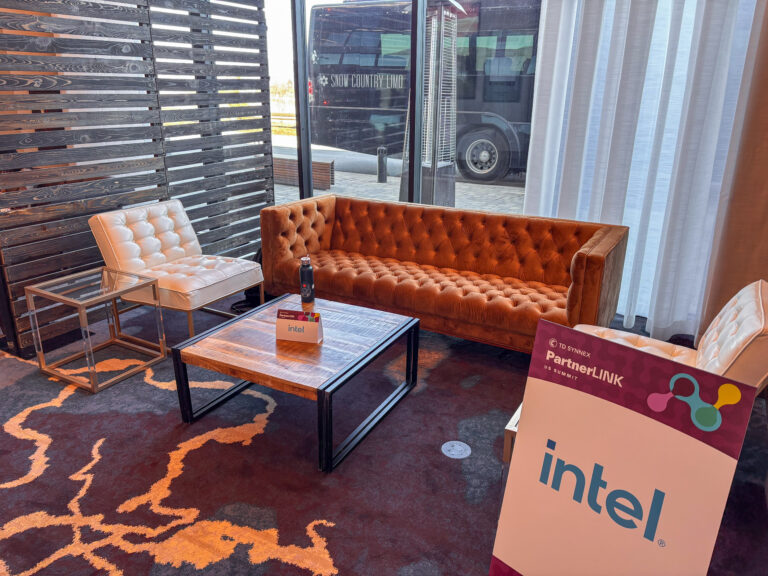 Modern corporate event lounge featuring a rust velvet tufted Chandler sofa, white tufted lounge Panelist chairs, reclaimed wood coffee table, and acrylic side tables by In The Event.