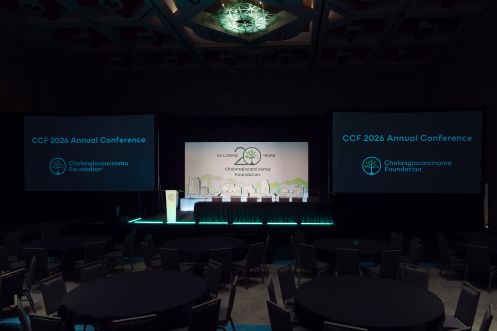 General session stage with custom scenic backdrop, dual projection screens, branded podium, and LED accent lighting at the CCF 2026 Annual Conference at the Salt Palace.