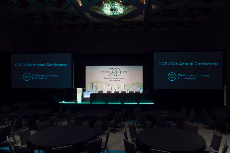 General session stage with custom scenic backdrop, dual projection screens, branded podium, and LED accent lighting at the CCF 2026 Annual Conference at the Salt Palace.