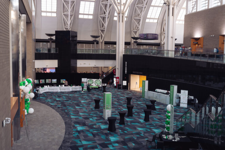 Wide overhead view of the registration and welcome area at the CCF 2026 Annual Conference at the Salt Palace Convention Center, featuring branded registration counters, event signage, and an open networking space.