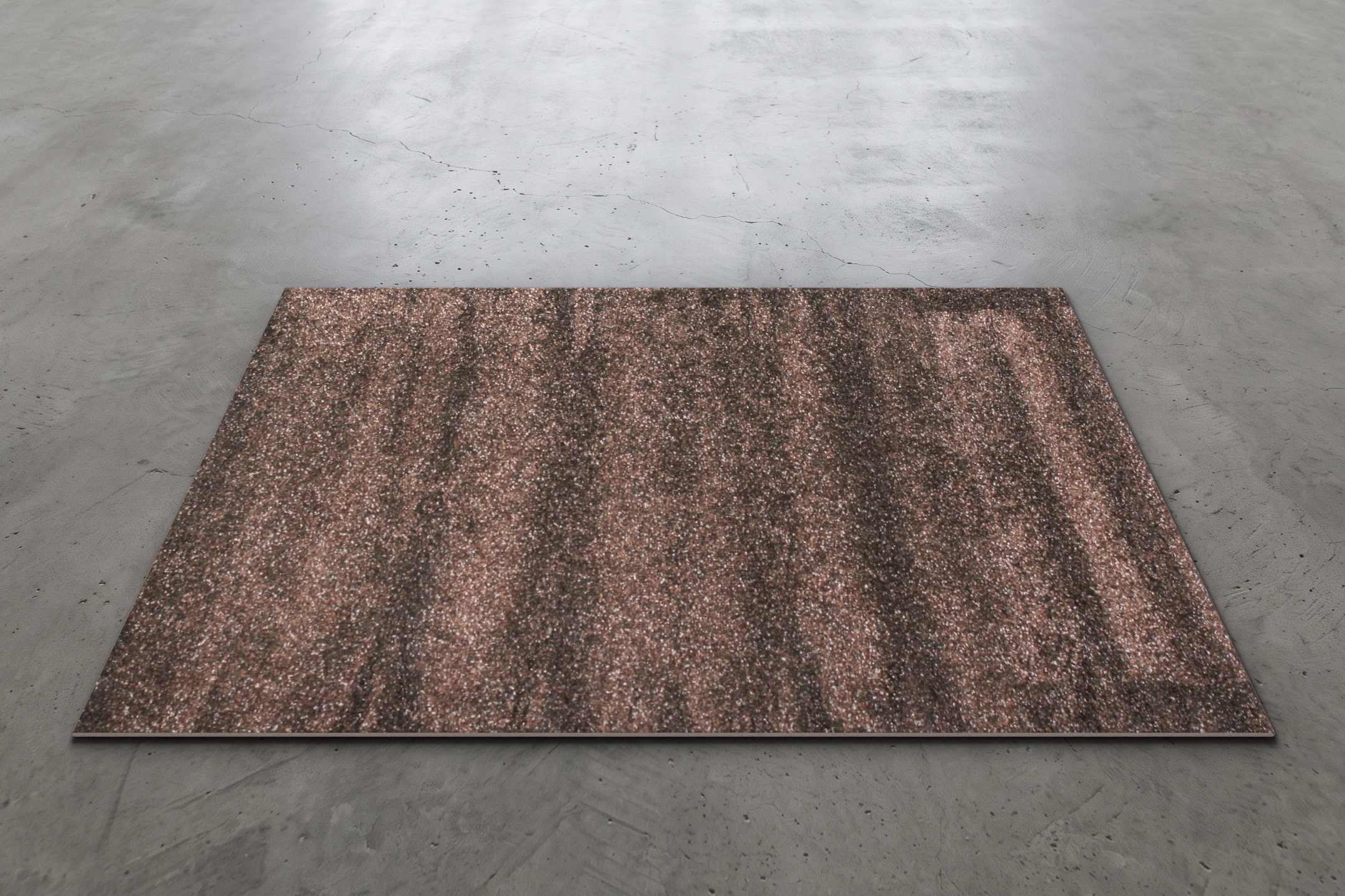 Mottled brown shag event rug measuring 6.5 by 4.5 feet, shown on a concrete floor