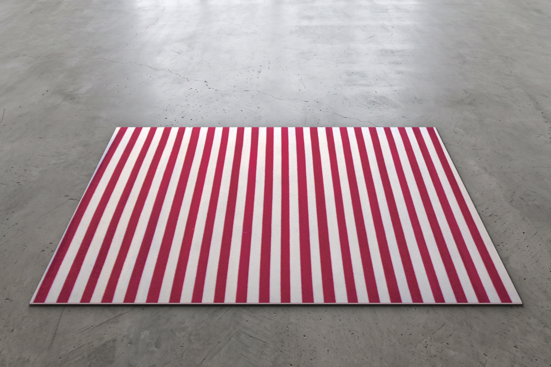 Bold red and white striped event rug measuring 7.5 by 5 feet, shown on a concrete floor