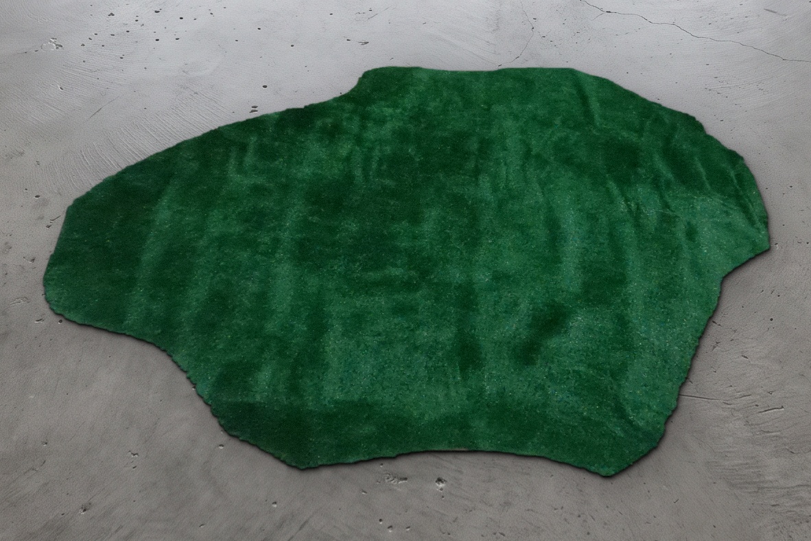 Dark green putting turf cut to an irregular shape, measuring 8 by 6 feet, shown on a concrete floor